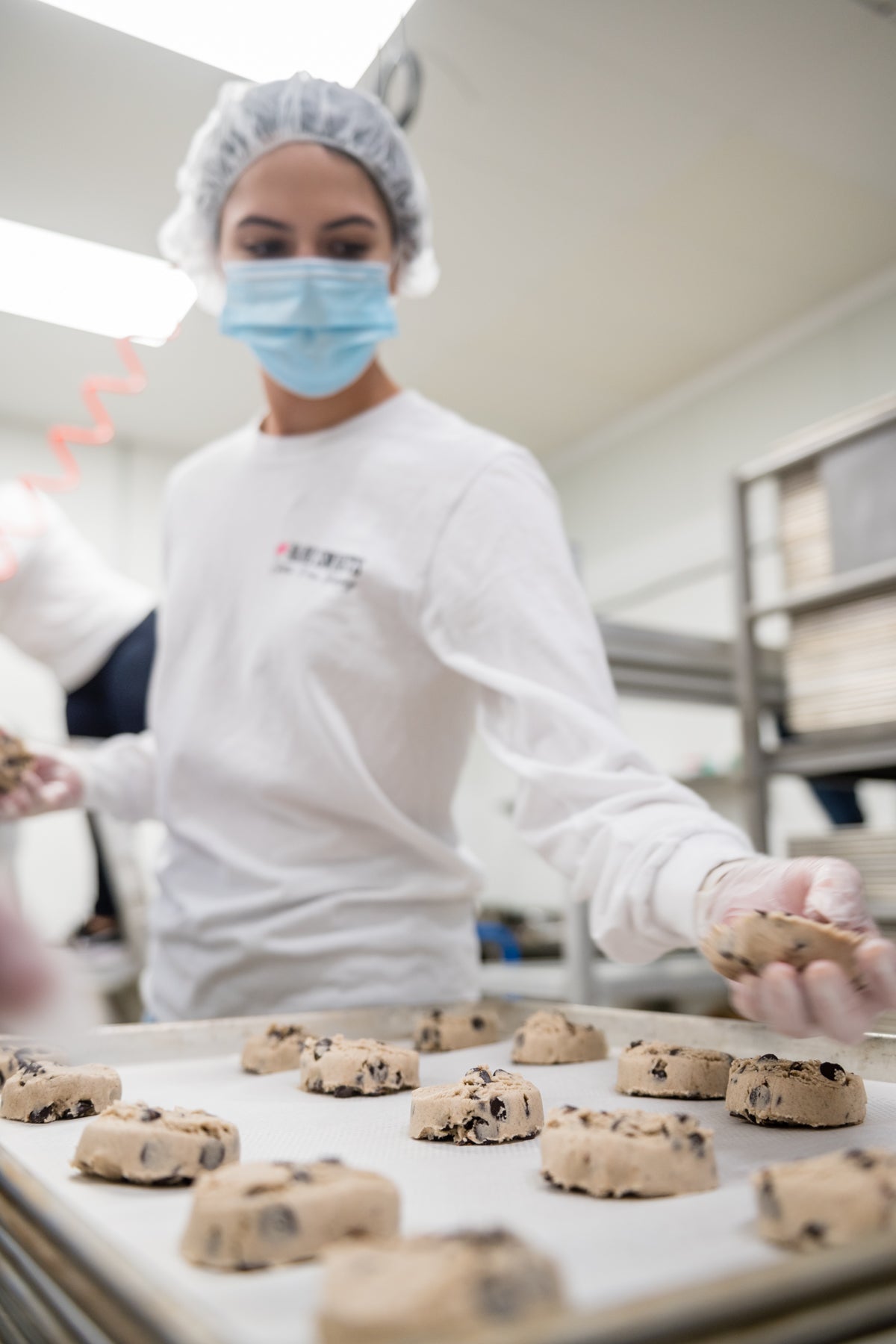 woman making cookies at factory